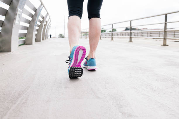 istock Beautiful young woman running on bridge during a training session in spring afternoon 681214554