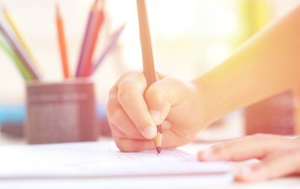 istock Little kid's hand drawing something on white paper. 681215742