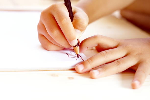 istock Little kid's hand drawing a car on white paper 681216310