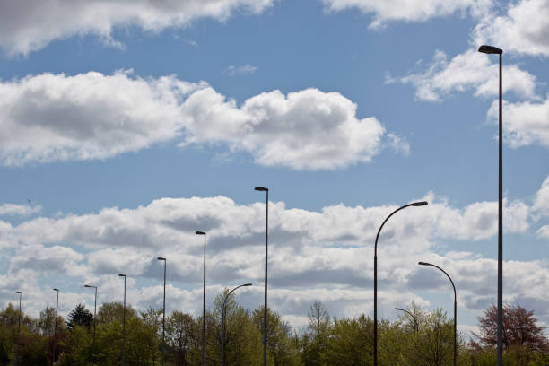Street lights against a cloudy sky.