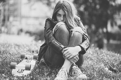 Depressed teenage girl in the city park