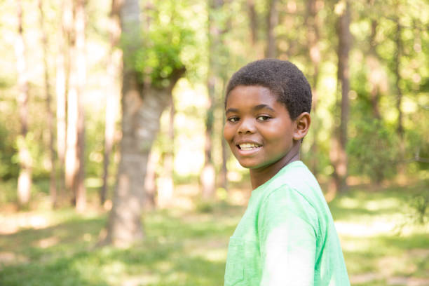 istock Pre-adolescent, African descent boy outdoors in spring or summer. 681230338