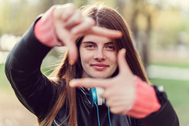 istock Teenage girl making frame with hands 681230384