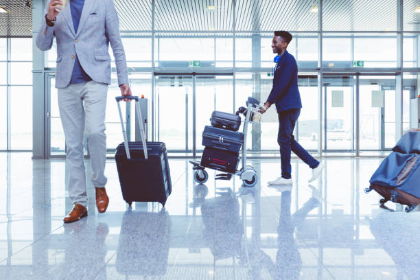 istock People walking at airport with luggage 681235514