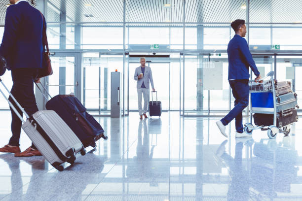 istock People with luggage walking at airport 681244004