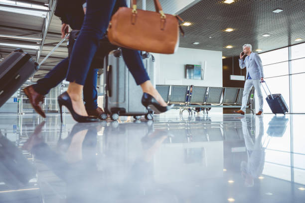 istock People walking with suitcases in airport terminal 681249082
