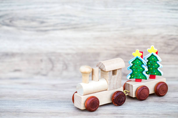 istock Miniature Figure Toy Wooden Train carry Christmas tree 681257206