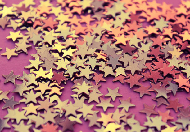 istock Background with small golden whitish stars on a rosy background 681257904