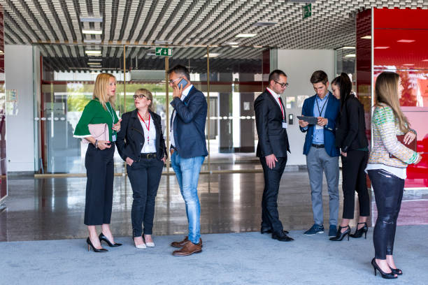 istock Business people talking in the office building lobby 681257910