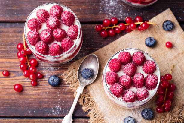 istock Raspberry dessert, cheesecake, trifle, mouse in a glass on a wooden background. Top view 681265706