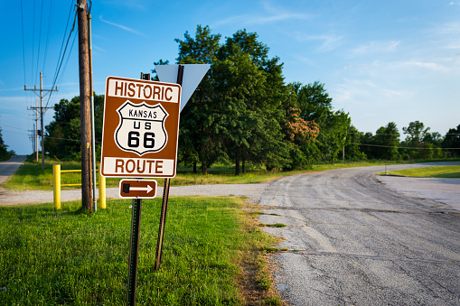 Historic Route 66 road sign in a stretch of the original road in the State of Kansas, USA; Concept for travel in the USA and Road Trip