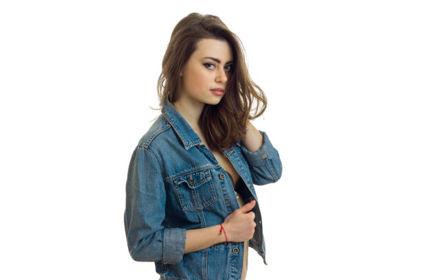 charming brunette in jeans jacket looks into a camera close-up of isolated on white background