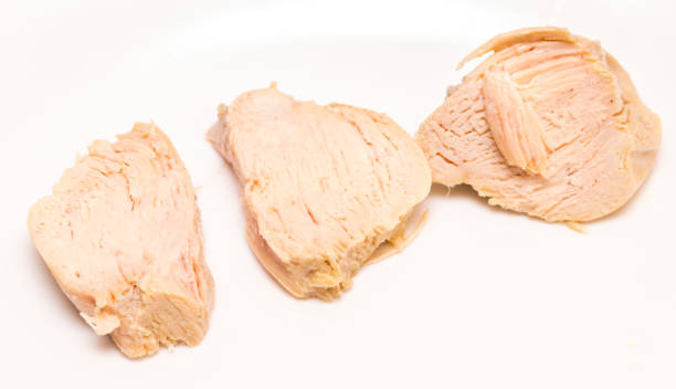 Pieces of boiled chicken breast over white background stock photo
