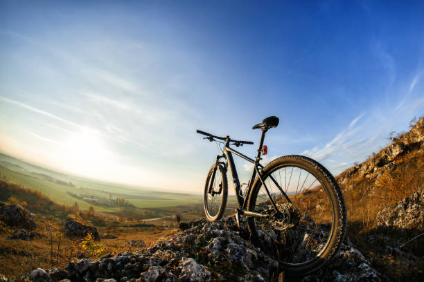 istock Bicycle silhouettes with blue sky on the mound 681297142