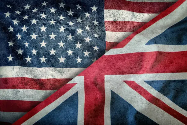 Photo of Mixed Flags of the USA and the UK. Union Jack flag.Flags of the USA and the UK Divided Diagonally.