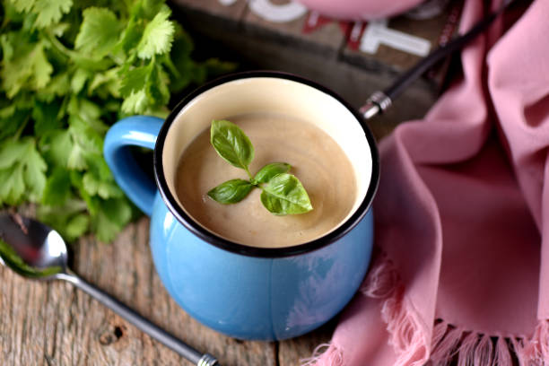 Chicken cream soup with cheese in mug.