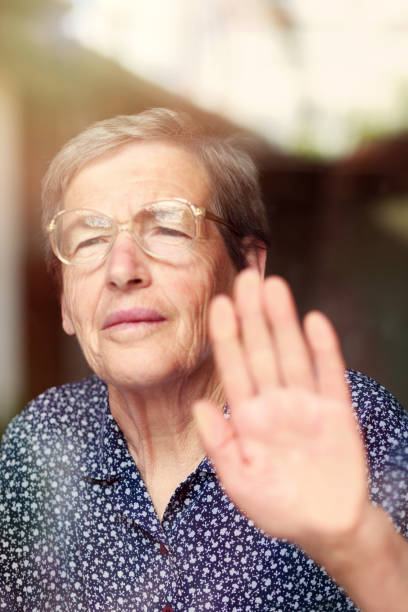 istock Senior woman behind the window 681325582
