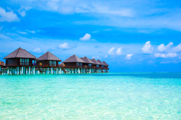 istock beach with water bungalows at Maldives 681329294