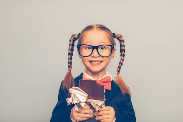 istock Young Female Nerd Eating a Chocolate Bar 681339874