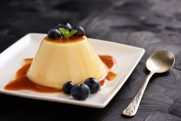 Cream pudding with caramel sauce and blueberries. stock photo