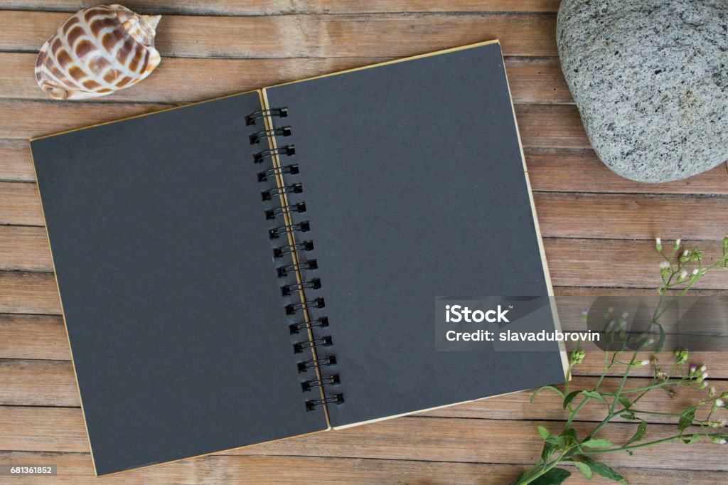 Black Paper Notebook On Rustic Wooden Background With Natural Decor Stock  Photo - Download Image Now - iStock