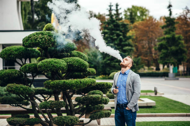 istock Men with beard smoking electronic cigarette outdoor 681364842