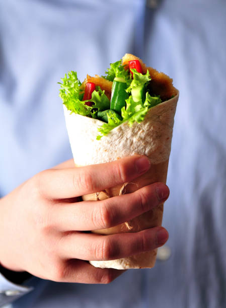 istock Tortilla roll with grilled chicken, red pepper, cucumber and lettuce. 681382986
