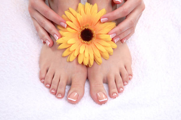 istock pedicure on legs and beautiful manicure on hands closeup 681396384