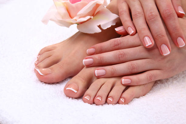 istock pedicure on legs and beautiful manicure on hands closeup 681396618