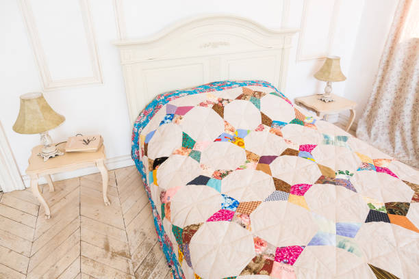 istock home atmosphere, homecraft, patchwork, quilting, sewing concept - comefort zone in light shades with two bedside table with lamps on them and bed covered in colorful blanket sewed with various patches 681401548