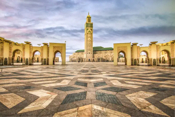 Huge empty square with paved  on the ground in front of the Minarett of Hassan II Mosque.