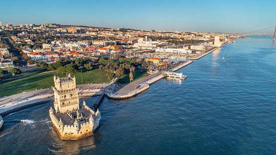 Aerial panorama of Belem Tower and Belem district at sunset.Tower of St Vincent on the bank of the Tagus River with discovery monument and 25 April bridge.Lisbon,Portugal.Amazing destinations