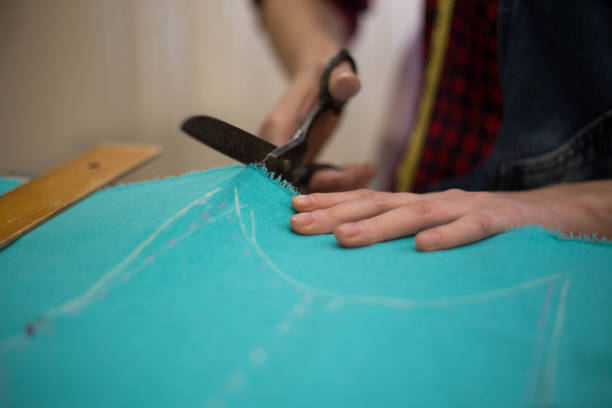 istock Seamstress woman preparing material 681407716