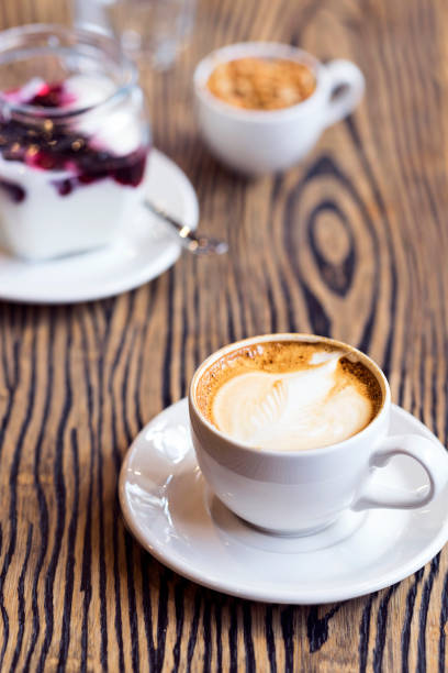 istock White cup of coffee on wooden table 681419980