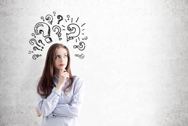 istock Pensive girl and question marks, concrete 681439916