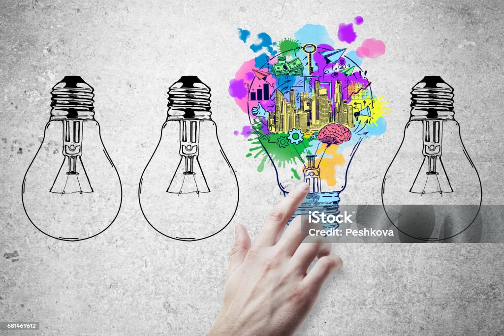 Idea concept Hand pointing at abstract drawn lamps and business sketch on concrete background. Idea concept Entrepreneur Stock Photo