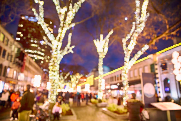 Christmas lights and people walking around on the street. Quincy Market, Boston USA. blurred background due to the concept