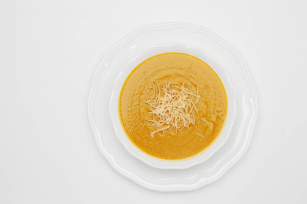 istock Plate of pea soup served with cheese on white background. Top view 681477532