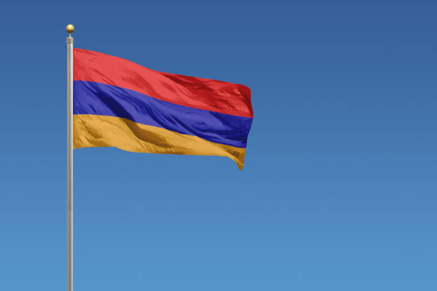 National flag of Armenia in front of a clear blue sky stock photo