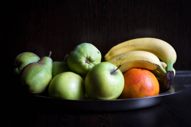 istock Fruits at the dark wooden kitchen 681498570