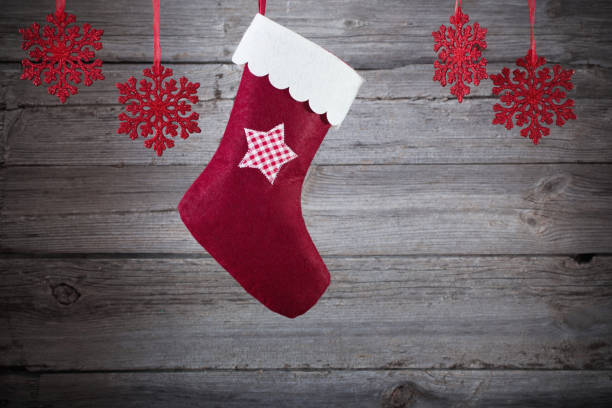 istock Christmas stocking hanging against wooden background 681506686