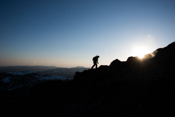 istock Backpacker hiking up into the mountains at sunset 681512148