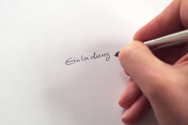 istock Hand writing Einladung (German for Invitation) in handwriting on white paper 681523896