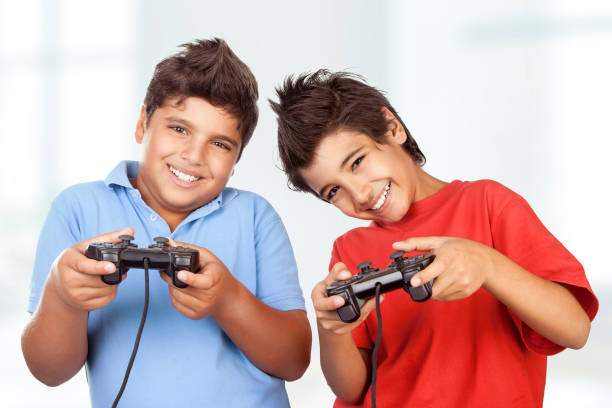 istock Two cute happy boys playing video games 681526926