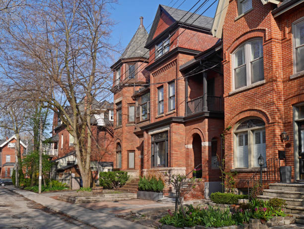 istock street with Victorian style brick houses 681570046