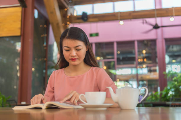 istock Young woman love reading book and drinking hot tea 681580760