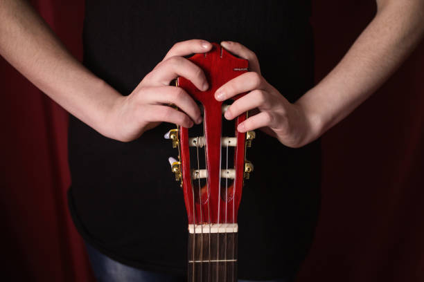 istock hands on the guitar fretboard 681583094