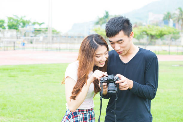 istock Friendship - two friends looking at photos in camera 681596482