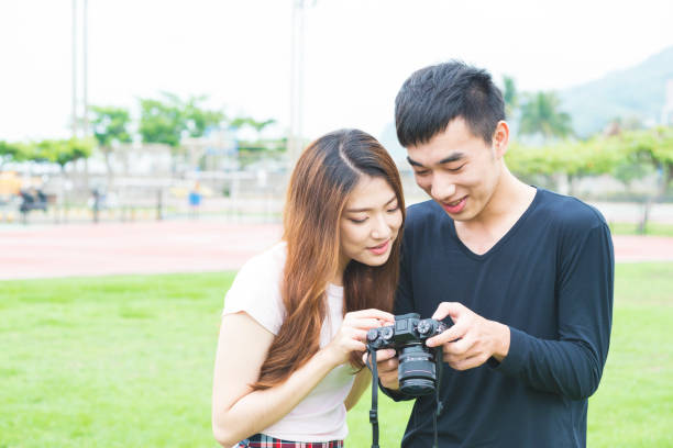 istock Friendship - two friends looking at photos in camera 681596504