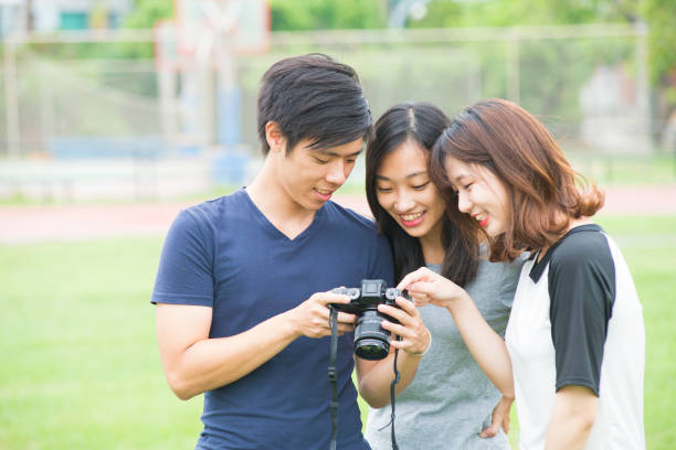 istock Friendship - three friends looking at photos on the camera 681597240